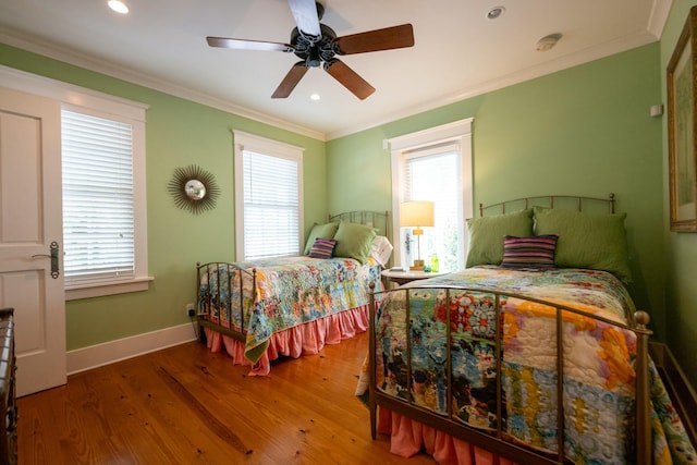 bedroom with recessed lighting, wood finished floors, a ceiling fan, baseboards, and ornamental molding