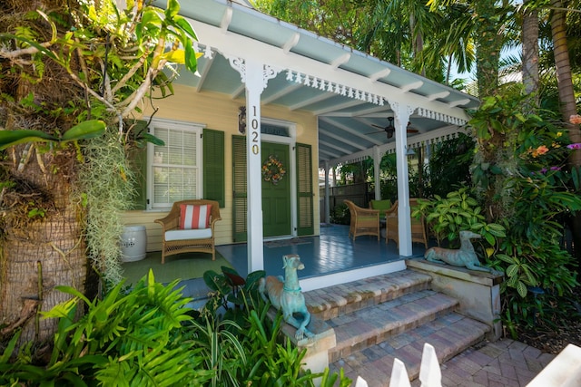 view of patio with ceiling fan and a porch