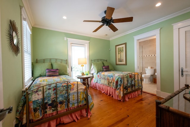 bedroom with ensuite bath, ornamental molding, wood finished floors, and recessed lighting