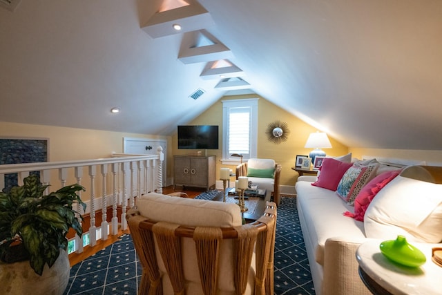 living area with visible vents and vaulted ceiling