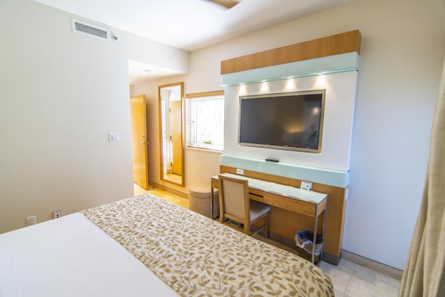 bedroom with light tile patterned floors