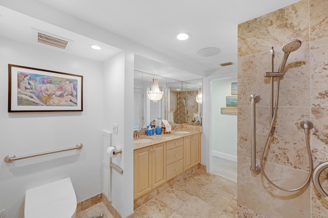 bathroom featuring visible vents, walk in shower, a sink, baseboards, and toilet