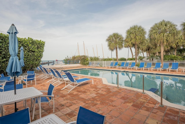 community pool featuring a patio and fence