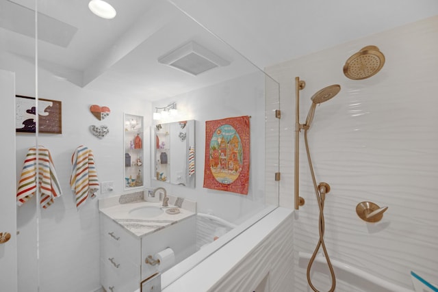 bathroom featuring vanity, walk in shower, and visible vents