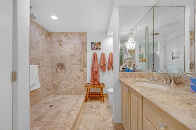 bathroom with vanity, an inviting chandelier, toilet, recessed lighting, and a tile shower