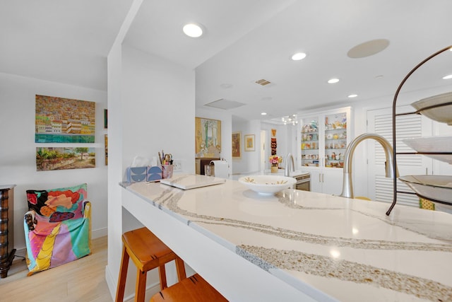 interior space with recessed lighting, visible vents, wood finished floors, and vanity