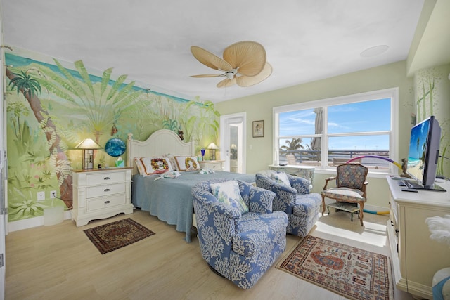 bedroom featuring baseboards, a ceiling fan, and wood finished floors