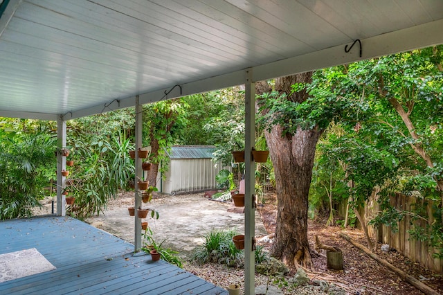 wooden terrace featuring a shed