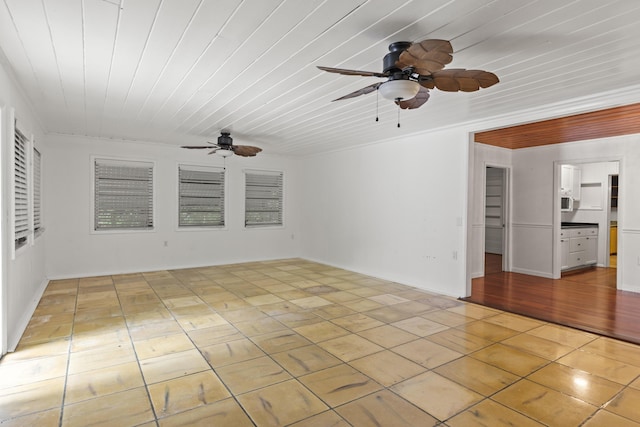 unfurnished room with light tile patterned floors, wooden ceiling, and ceiling fan