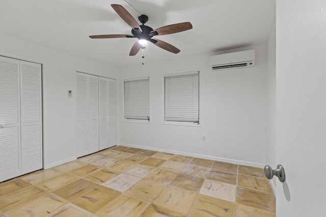 unfurnished bedroom with multiple closets, ceiling fan, and a wall mounted AC