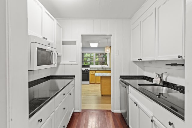 kitchen featuring sink, white appliances, dark hardwood / wood-style floors, and white cabinets