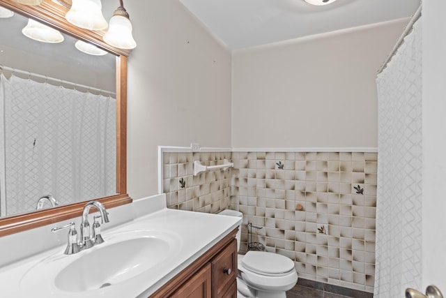 bathroom featuring tile patterned flooring, vanity, tile walls, and toilet