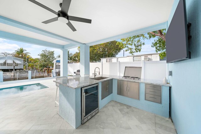 rear view of property featuring a balcony, a pool with hot tub, ceiling fan, and a patio area