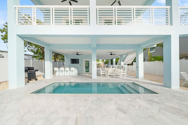 back of property with a patio area, ceiling fan, fence, and outdoor dry bar