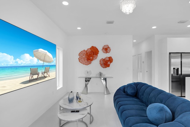 living room featuring a water view and a beach view