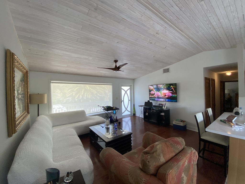 living room with wood ceiling, ceiling fan, lofted ceiling, and dark hardwood / wood-style flooring