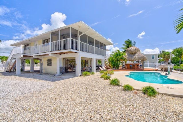 17166 W Wahoo Ln, Sugarloaf, FL 33042 - swimming pool with a patio, stairs, a sunroom, and ceiling fan