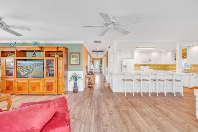 17166 W Wahoo Ln, Sugarloaf, FL 33042 - living room with a ceiling fan, ornamental molding, light wood-style floors, and wainscoting