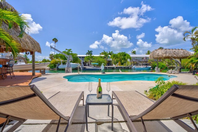 17166 W Wahoo Ln, Sugarloaf, FL 33042 - outdoor pool featuring a patio area, a dock, and boat lift