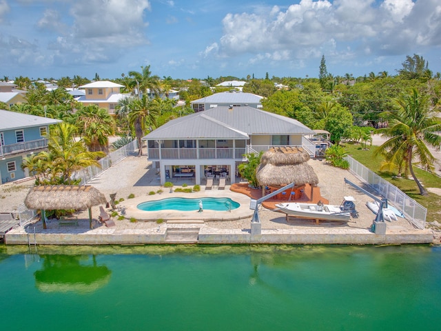 17166 W Wahoo Ln, Sugarloaf, FL 33042 - back of house featuring a fenced backyard, a patio area, a jacuzzi, a water view, and an outdoor pool