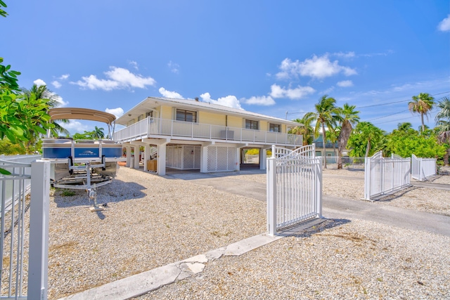 17166 W Wahoo Ln, Sugarloaf, FL 33042 - coastal home featuring a gate, a carport, and a balcony