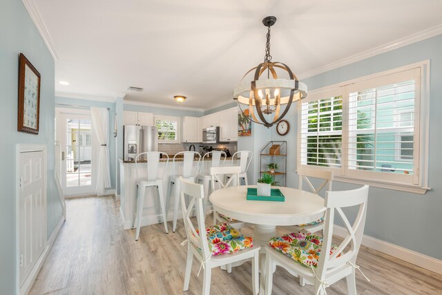 532 Porter Ln, Key West, FL 33040 - dining area featuring a chandelier, light wood-style flooring, ornamental molding, and baseboards