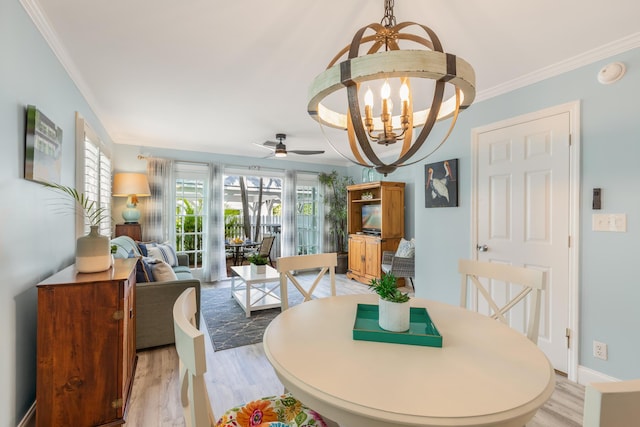 532 Porter Ln, Key West, FL 33040 - dining area with a chandelier, light wood-style flooring, a ceiling fan, and crown molding
