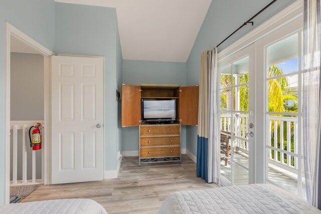 532 Porter Ln, Key West, FL 33040 - bedroom with wood finished floors, lofted ceiling, baseboards, and access to outside
