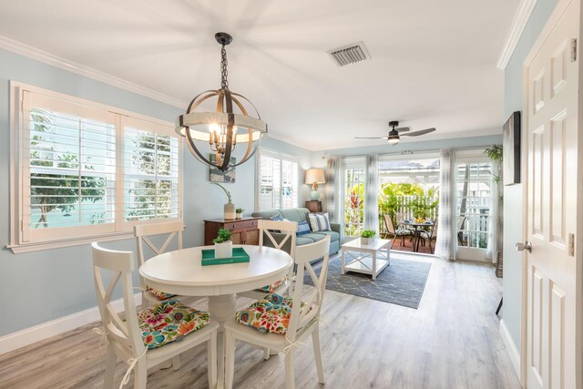 532 Porter Ln, Key West, FL 33040 - dining room with a chandelier, ornamental molding, light wood finished floors, baseboards, and ceiling fan