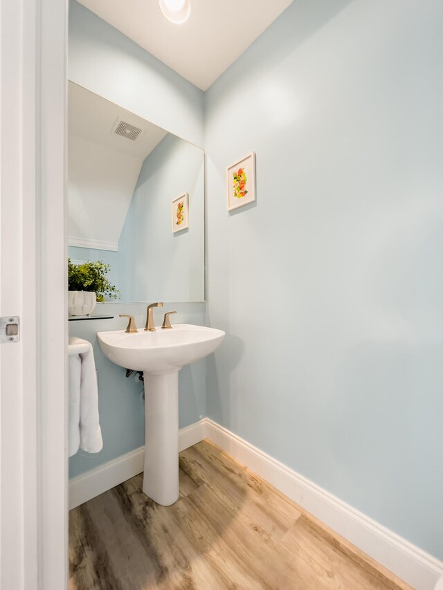 532 Porter Ln, Key West, FL 33040 - bathroom featuring baseboards, wood finished floors, and vaulted ceiling