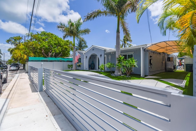 3034 Riviera Dr, Key West, FL 33040 - exterior space with stucco siding and a fenced front yard