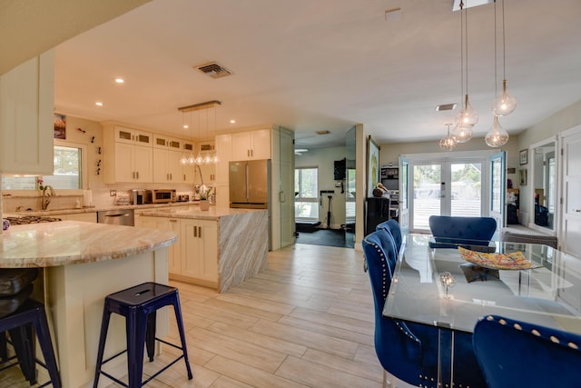 3034 Riviera Dr, Key West, FL 33040 - kitchen with decorative backsplash, a center island, light stone counters, and stainless steel appliances