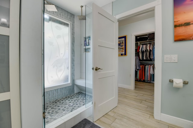 3034 Riviera Dr, Key West, FL 33040 - full bath featuring a spacious closet, a shower stall, wood finished floors, and baseboards