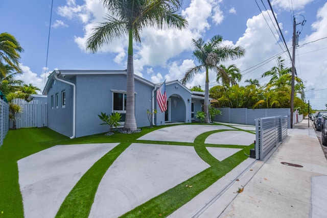 3034 Riviera Dr, Key West, FL 33040 - view of front of house featuring a front yard, fence, and stucco siding