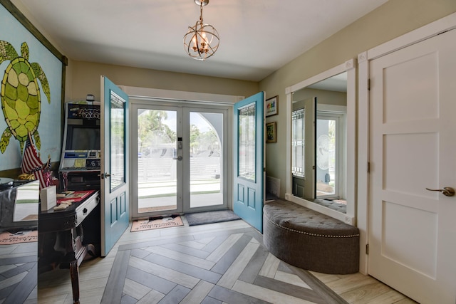 3034 Riviera Dr, Key West, FL 33040 - foyer entrance featuring french doors and an inviting chandelier