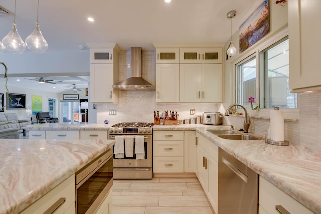 3034 Riviera Dr, Key West, FL 33040 - kitchen with wall chimney range hood, a ceiling fan, appliances with stainless steel finishes, a sink, and open floor plan