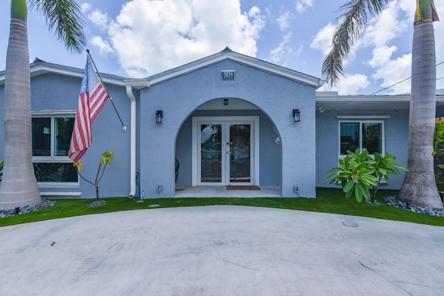 3034 Riviera Dr, Key West, FL 33040 - exterior space with french doors, a front lawn, and stucco siding