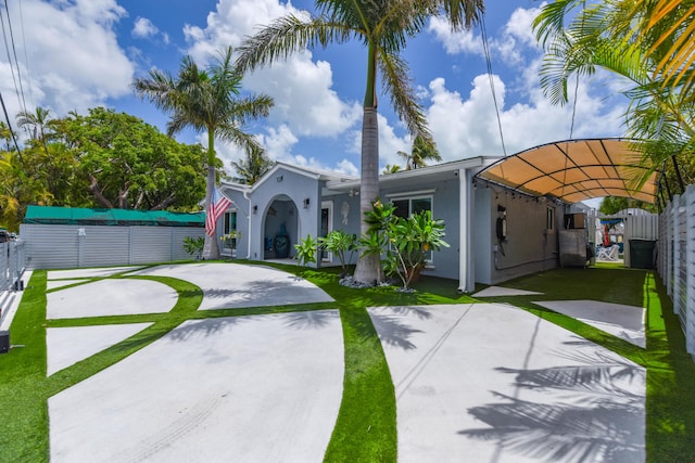 3034 Riviera Dr, Key West, FL 33040 - view of front of house with stucco siding, fence, and a front yard