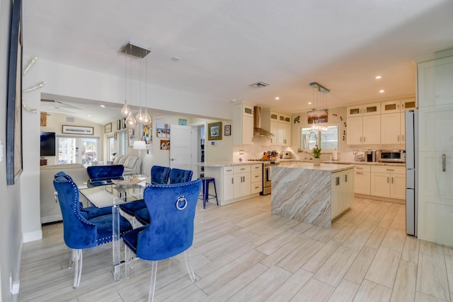 3034 Riviera Dr, Key West, FL 33040 - dining room with visible vents, a wealth of natural light, an inviting chandelier, and vaulted ceiling