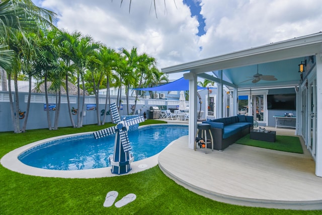 3034 Riviera Dr, Key West, FL 33040 - view of swimming pool featuring a fenced backyard, an outdoor living space, ceiling fan, and a lawn