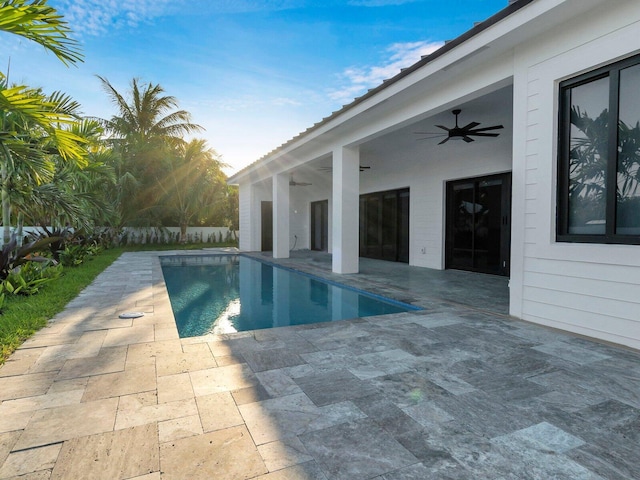 view of swimming pool featuring ceiling fan and a patio