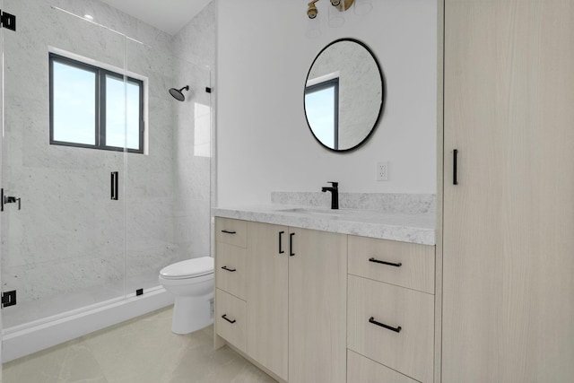 bathroom with vanity, a shower with shower door, tile patterned floors, and toilet