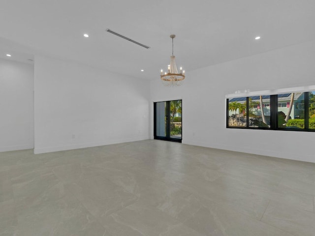 spare room with a chandelier