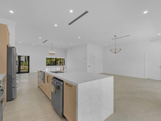 kitchen featuring light brown cabinetry, sink, pendant lighting, stainless steel appliances, and a large island