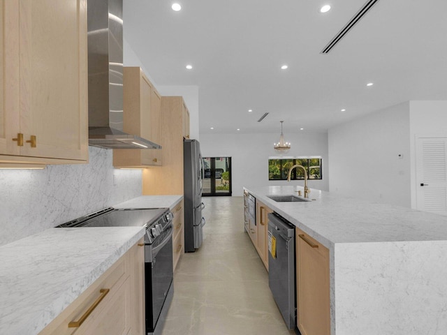 kitchen featuring a large island, wall chimney range hood, sink, stainless steel appliances, and light brown cabinets