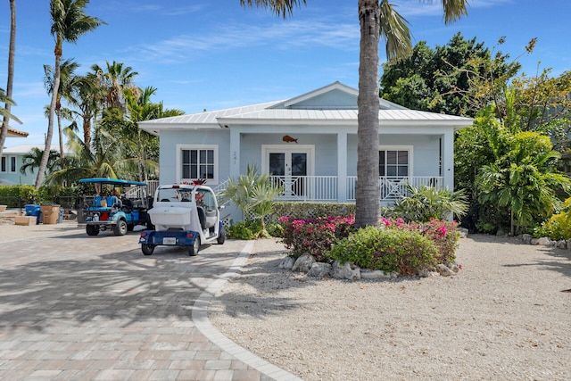 241 W Seaview Dr, Duck, FL 33050 - bungalow-style home with stucco siding, a standing seam roof, covered porch, and metal roof