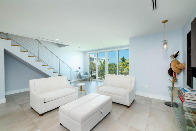 94825 Overseas Hwy Unit 204, Key Largo, FL 33037 - living room featuring recessed lighting, stairs, a wall of windows, and baseboards
