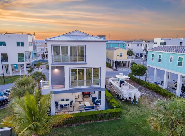 94825 Overseas Hwy Unit 204, Key Largo, FL 33037 - back of property featuring a standing seam roof, stucco siding, a residential view, metal roof, and an outdoor hangout area