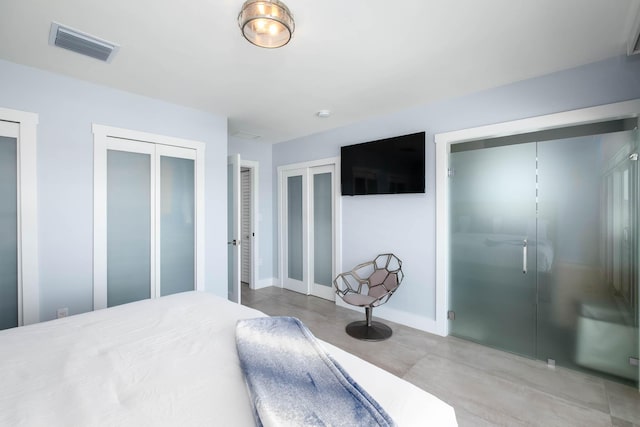 94825 Overseas Hwy Unit 204, Key Largo, FL 33037 - bedroom with multiple closets, concrete flooring, and baseboards