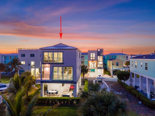 94825 Overseas Hwy Unit 204, Key Largo, FL 33037 - back of house featuring stucco siding, a balcony, a standing seam roof, and metal roof